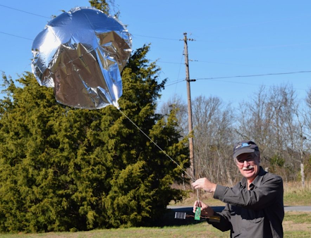 Bill Brown (WB8ELK) holding a pico-balloon